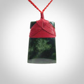 A medium sized and beautiful hand carved toki pendant. This piece is carved from New Zealand jade by NZ Pacific. This is a wonderful toki bound with a hand-plaited cord and a traditional lashing. A beautiful, traditional toki for sale online